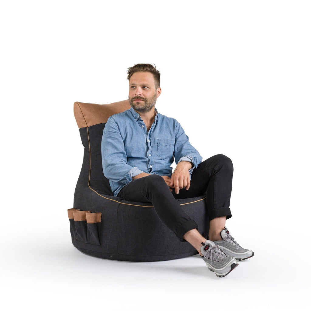 Man sitting on a modern bean bag chair with a white background