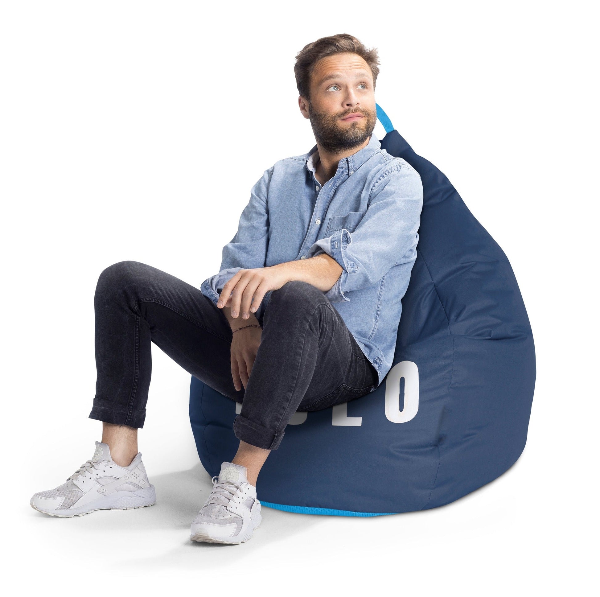 Man sitting on a blue bean bag chair with 'LOO' branding on a white background